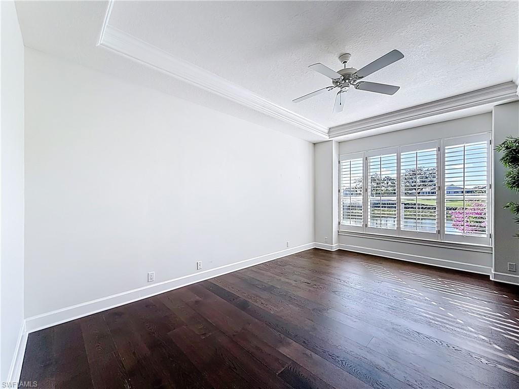 3051 Lancaster Drive, Unit 2 Naples, FL 34105 - Photo 10 of 43 a view of an empty room with wooden floor and a window