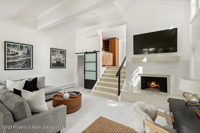 a living room with furniture fireplace and flat screen tv