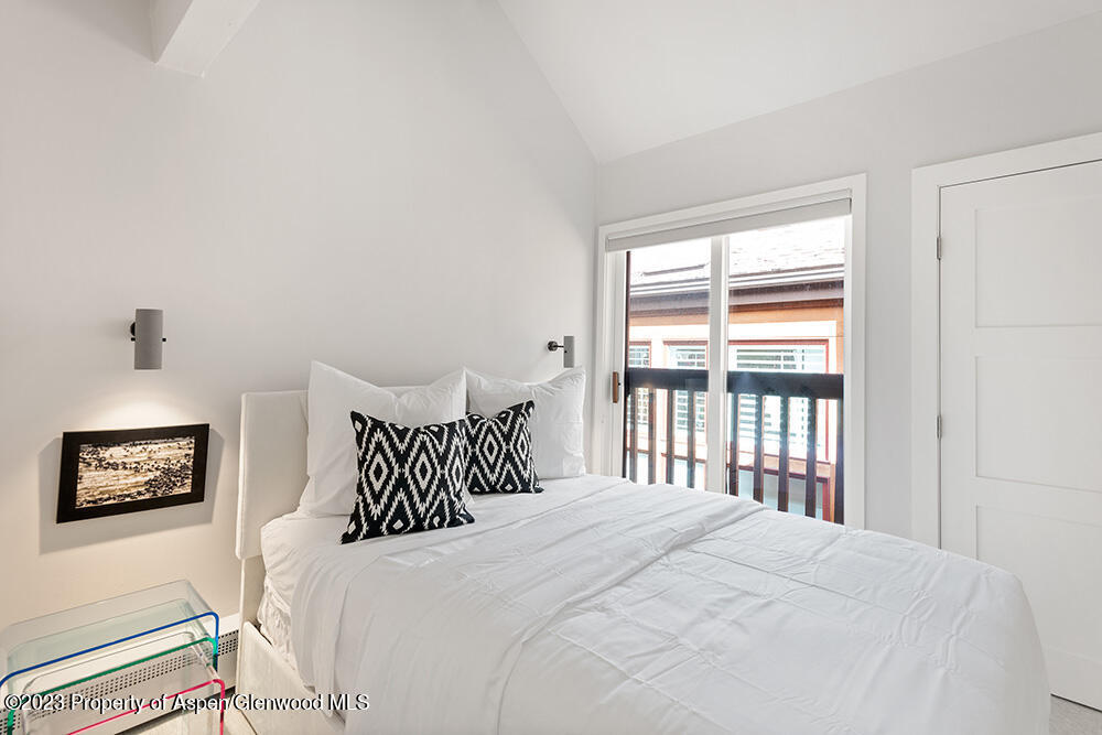 900 East Durant Avenue, Unit 116 Aspen, CO 81611 - Photo 12 of 19 a bedroom with a bed and a window