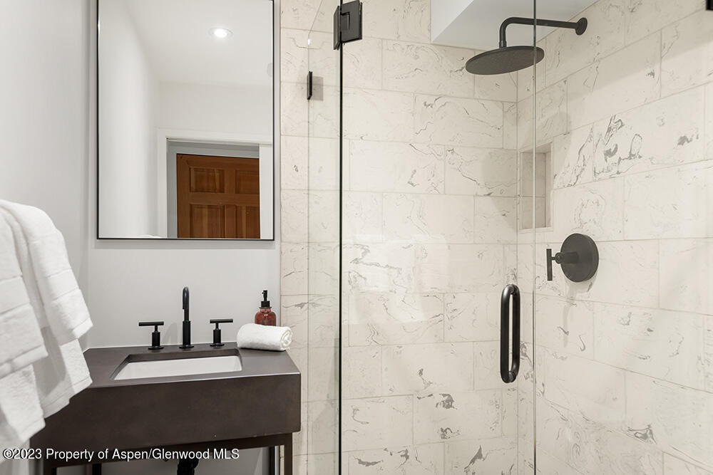 900 East Durant Avenue, Unit 116 Aspen, CO 81611 - Photo 18 of 19 a bathroom with a sink and a mirror