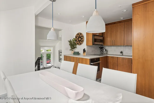 a kitchen with a white center island a stove and a wooden floor