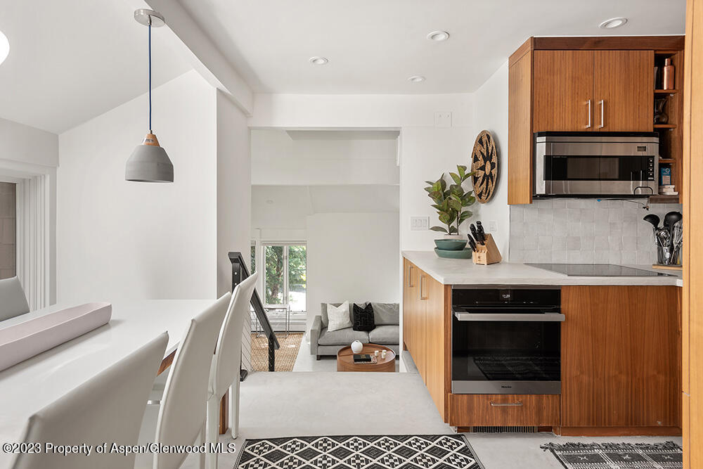 900 East Durant Avenue, Unit 116 Aspen, CO 81611 - Photo 7 of 19 a living room with furniture and a fireplace