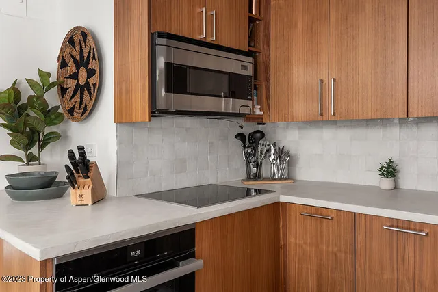 a kitchen with a sink a microwave and cabinets