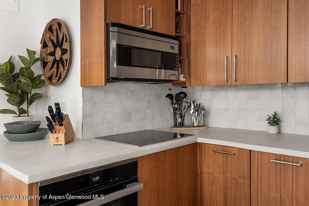 900 East Durant Avenue, Unit 116 Aspen, CO 81611 - Photo 8 of 19 a kitchen with a sink a microwave and cabinets