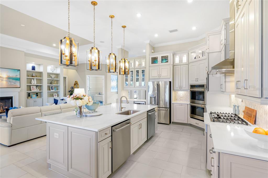 8232 Summer Night Road Sarasota, FL 34241 - Photo 12 of 82 a kitchen with stainless steel appliances granite countertop a sink a stove and a refrigerator
