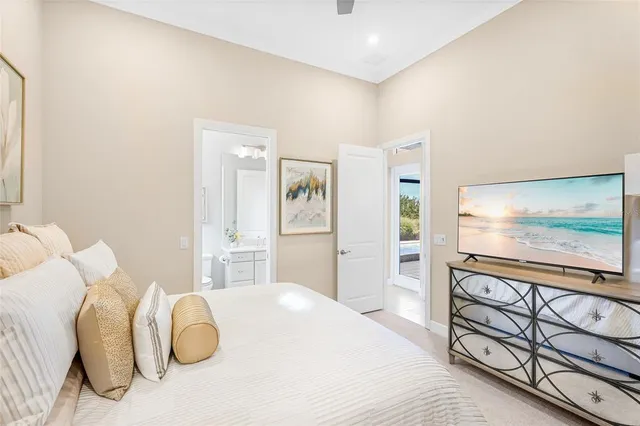 a bedroom with a bed and a chandelier