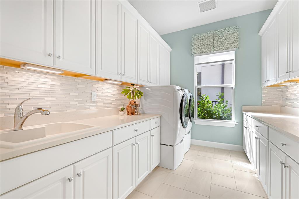 8232 Summer Night Road Sarasota, FL 34241 - Photo 28 of 82 a utility room with cabinets washer and dryer