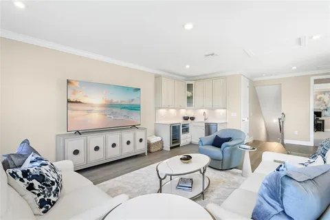 a view of a house with backyard outdoor seating and hardwood