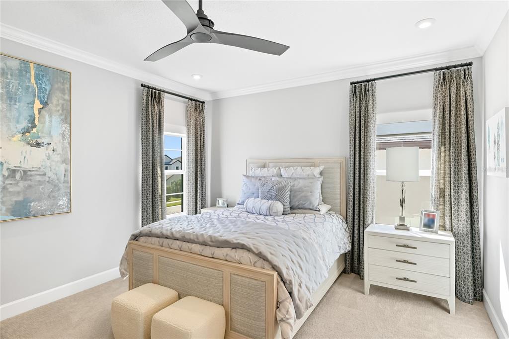 8232 Summer Night Road Sarasota, FL 34241 - Photo 35 of 82 a bedroom with a bed and a chandelier