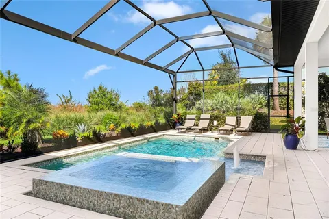 a view of a swimming pool with a outdoor seating