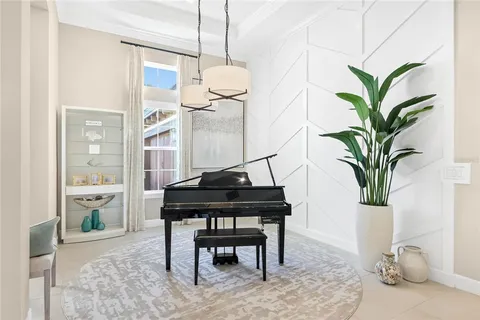 a living room with furniture a fireplace and a potted plant