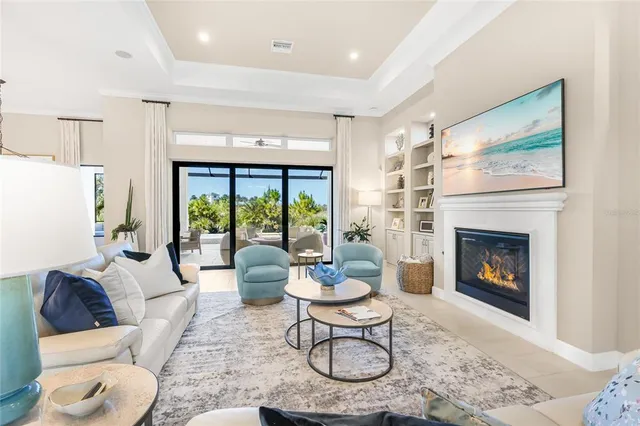 a living room with furniture fireplace and a large window