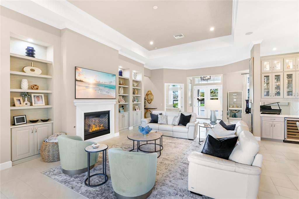 8232 Summer Night Road Sarasota, FL 34241 - Photo 6 of 82 a living room with furniture a fireplace and a potted plant