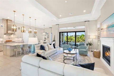 a kitchen with stainless steel appliances granite countertop a sink a stove and a refrigerator