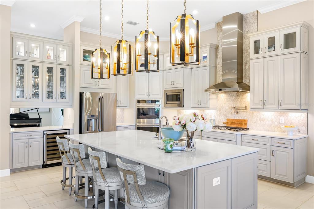 8232 Summer Night Road Sarasota, FL 34241 - Photo 10 of 82 a kitchen with stainless steel appliances kitchen island granite countertop a table chairs and a refrigerator