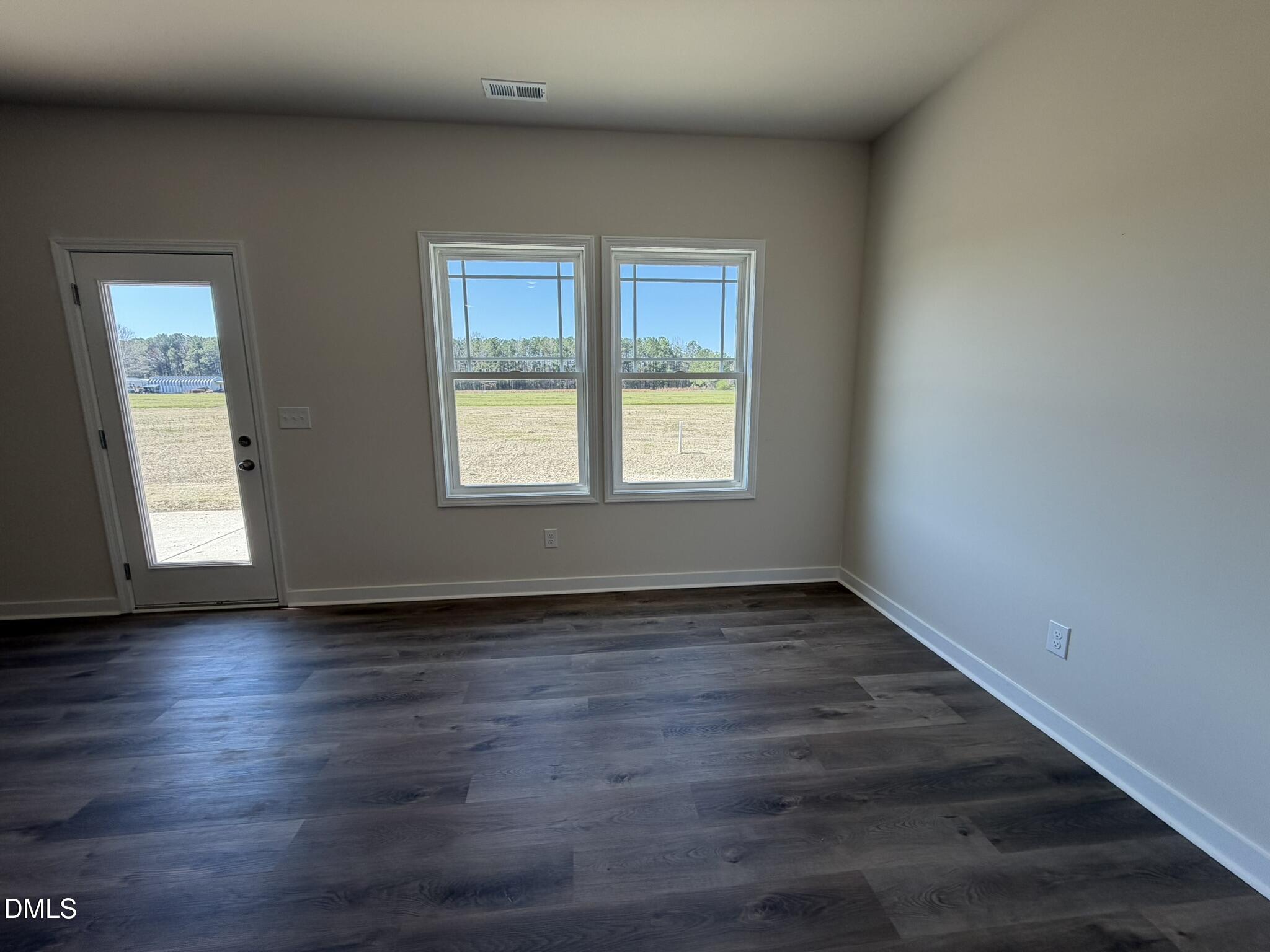 159 Jacobs Ridge Drive Four Oaks, NC 27524 - Photo 8 of 18 a view of an empty room with wooden floor and a window