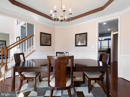 a view of a dining room with furniture and a chandelier