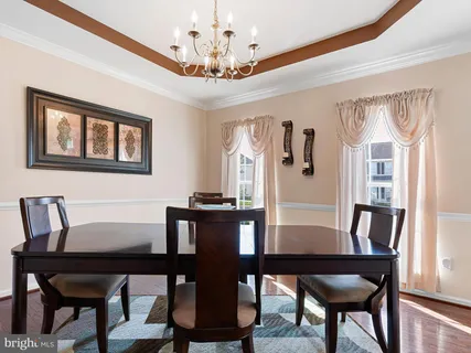 a view of a dining room with furniture and a chandelier