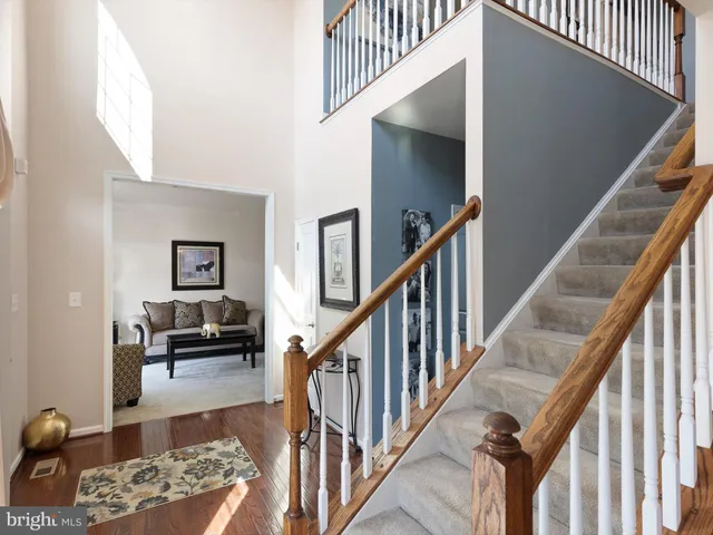 a view of a livingroom with furniture and staircase