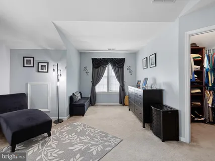a bedroom with a bed and a book shelf