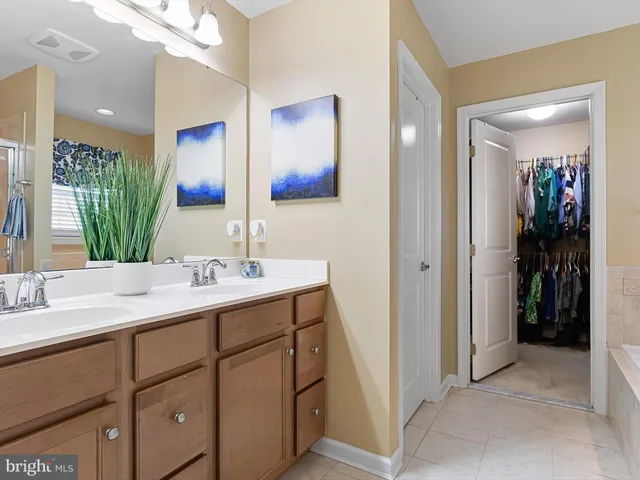 a bathroom with a double vanity sink and mirror