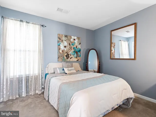 a bedroom with a bed and a large window