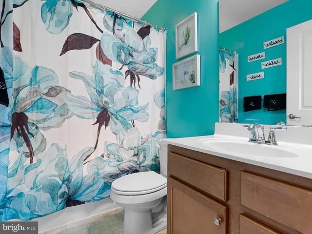 a bathroom with a sink a mirror and a toilet