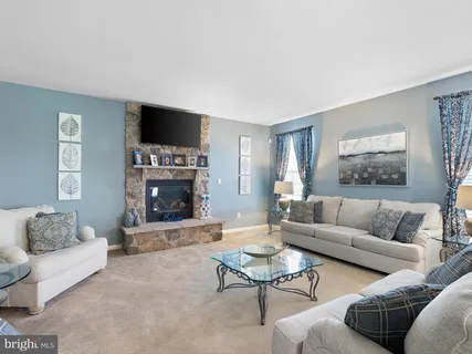 a living room with furniture a rug and a flat screen tv