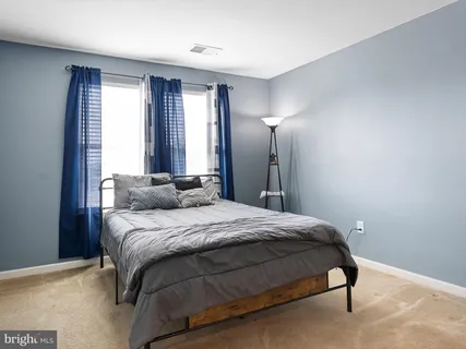 a bedroom with a bed and lamp