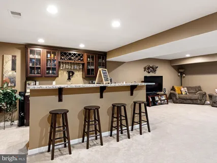 a dinning room with stainless steel appliances kitchen island a table and chairs in it