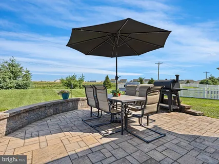 a view of a terrace with furniture and umbrella