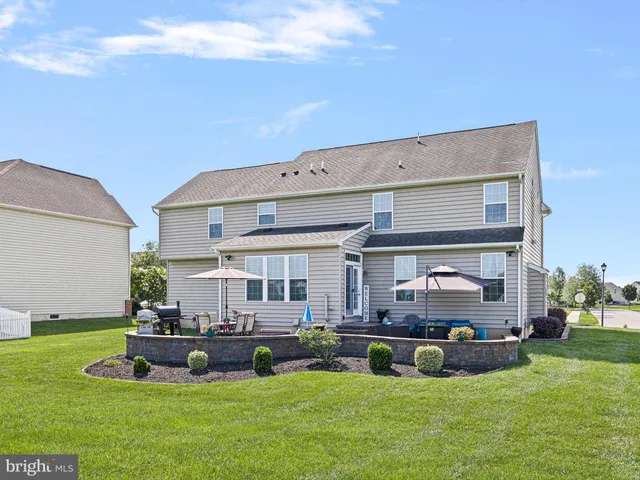a view of an house with backyard porch and sitting area