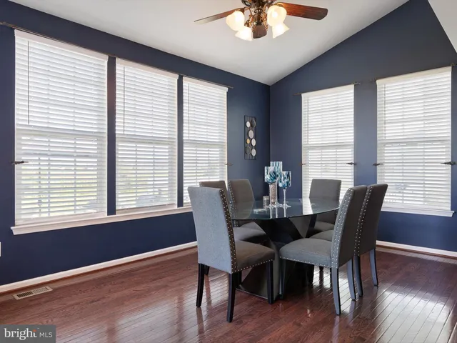 a view of a dining room with furniture windows and wooden floor