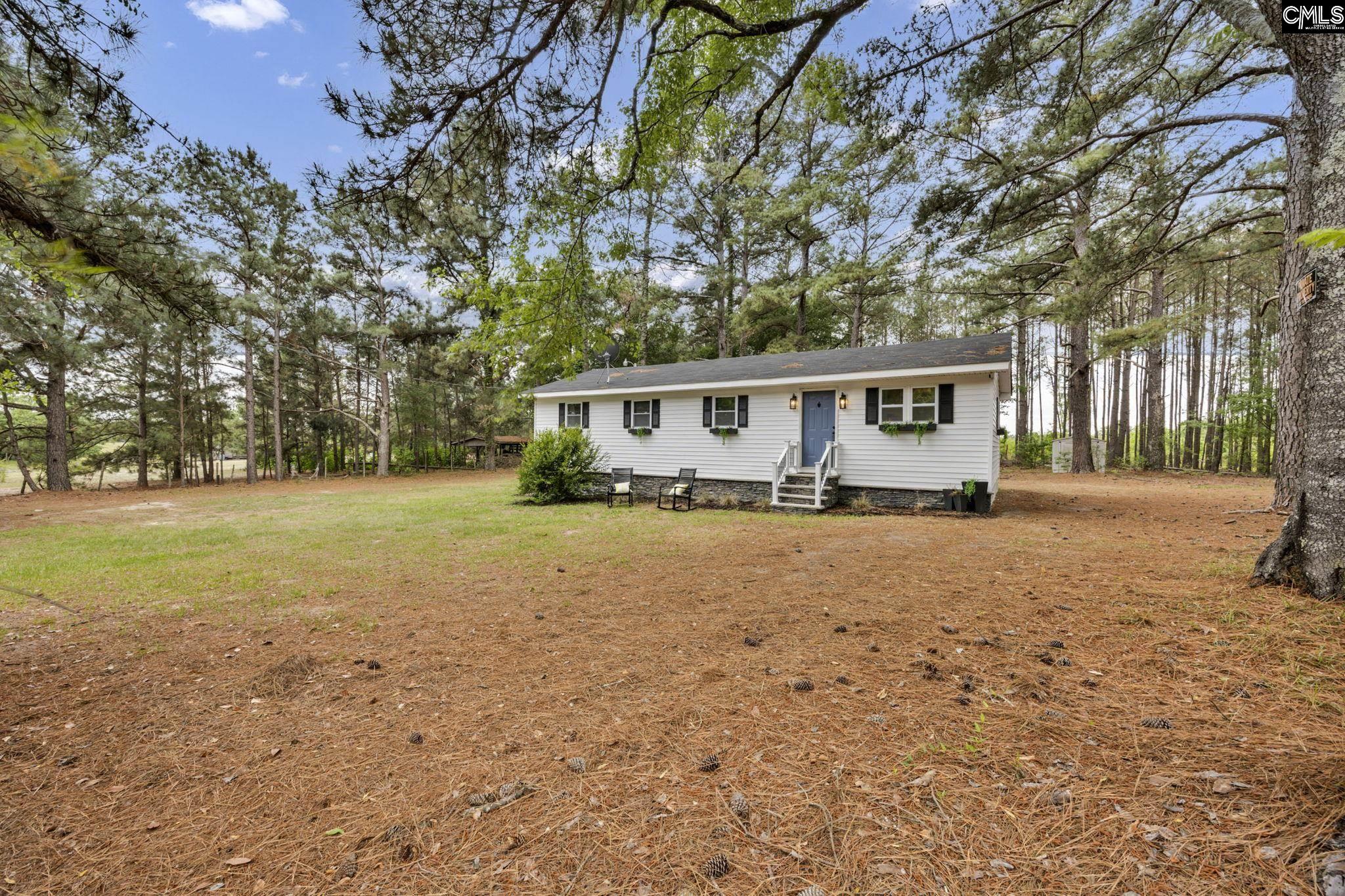 8107 Black River Road Rembert, SC 29128 - Photo 36 of 38 a view of house with yard and trees in the background