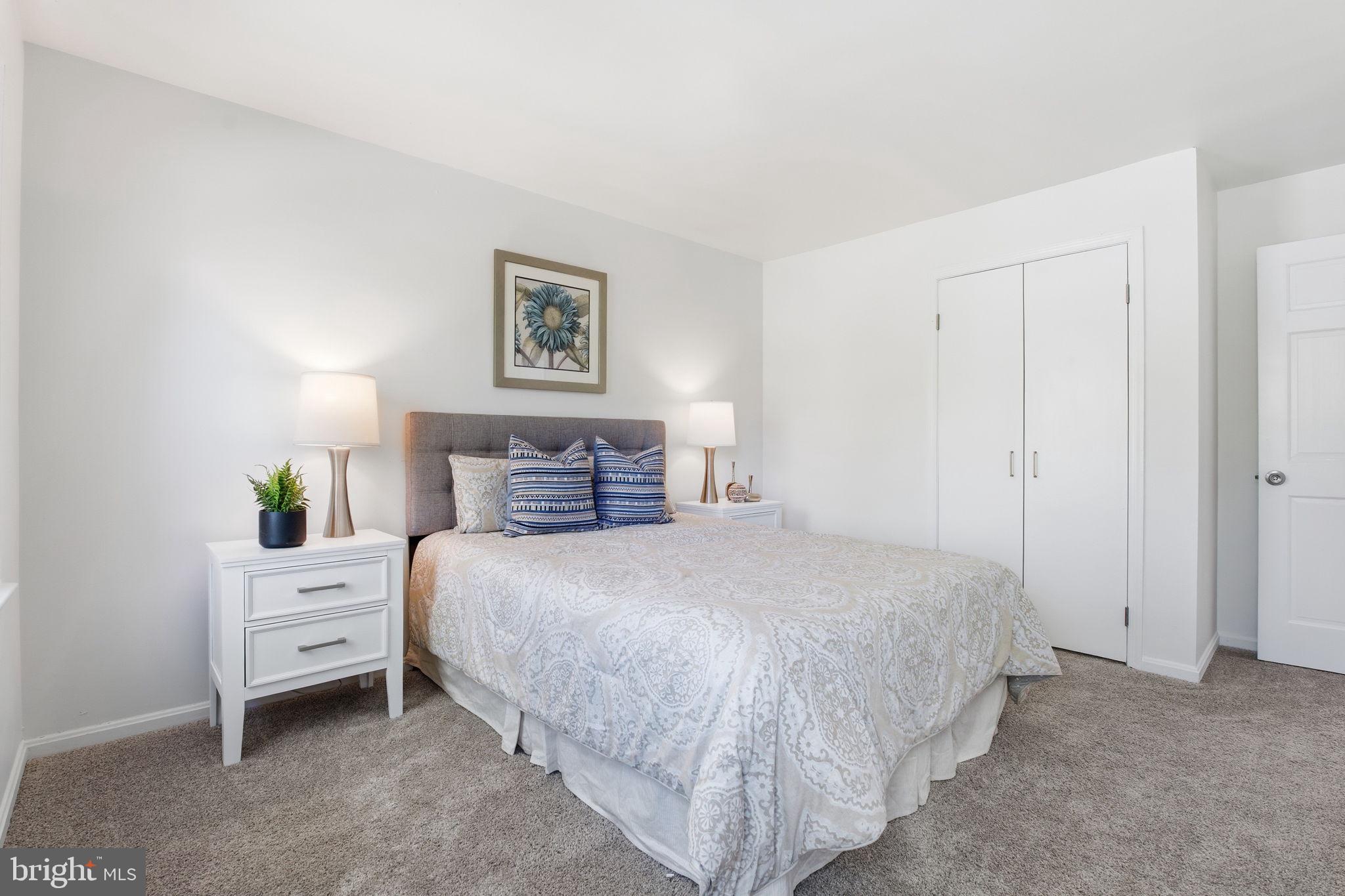 15101 Redgate Drive Silver Spring, MD 20905 - Photo 29 of 39 a bedroom with a bed and a night stand
