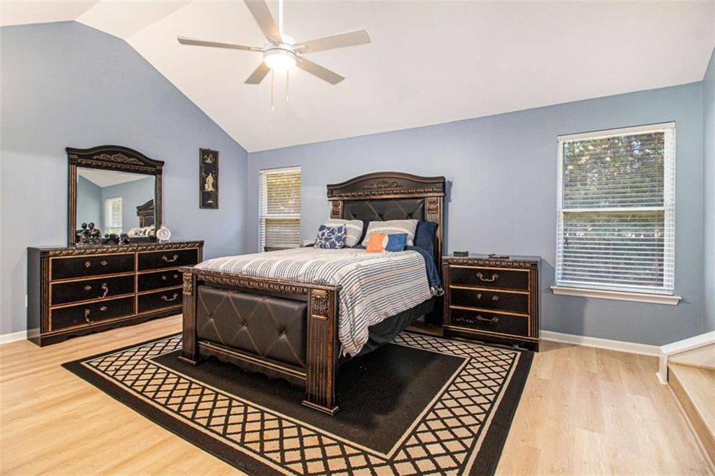 550 Windsor Way Fairburn, GA 30213 - Photo 14 of 28 a bedroom with a bed and dresser