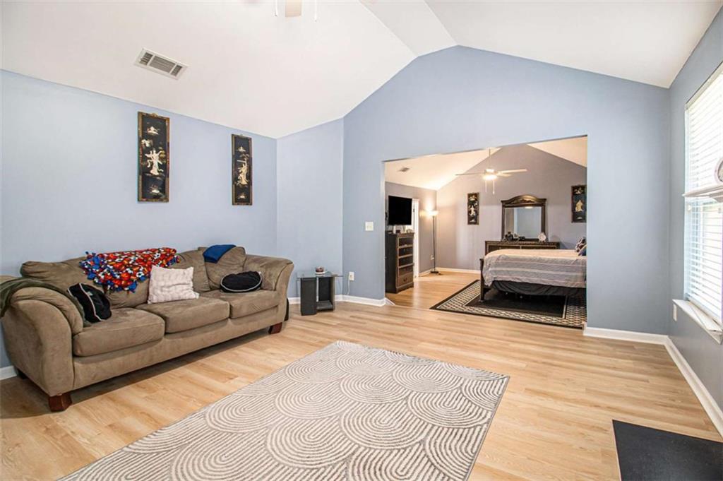 550 Windsor Way Fairburn, GA 30213 - Photo 15 of 28 a bedroom with a bed and a couch