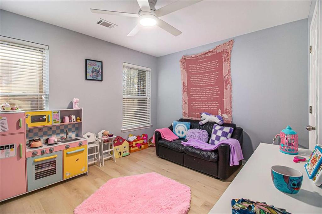 550 Windsor Way Fairburn, GA 30213 - Photo 19 of 28 a bedroom with bed and a couch