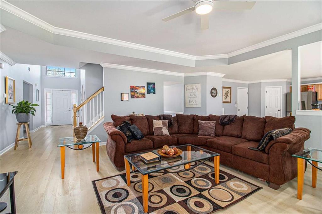 550 Windsor Way Fairburn, GA 30213 - Photo 5 of 28 a living room with furniture and wooden floor