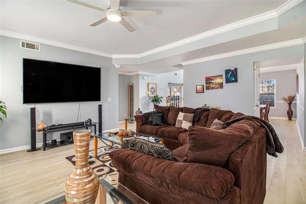 550 Windsor Way Fairburn, GA 30213 - Photo 6 of 28 a living room with furniture and a flat screen tv