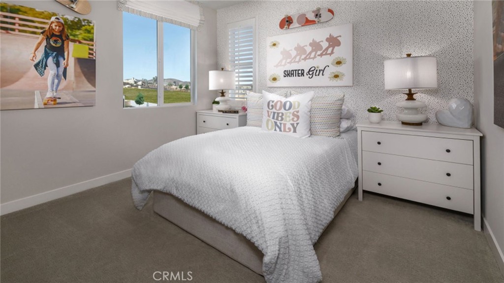 2395 Huron Road Rialto, CA 92377 - Photo 14 of 17 a large bed sitting in a bedroom next to a window