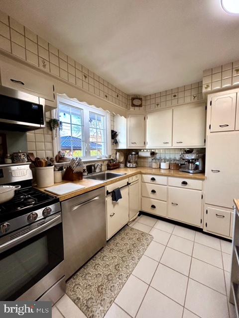 9203 Burbank Road Philadelphia, PA 19115 - Photo 30 of 62 a kitchen with stainless steel appliances and white cabinets