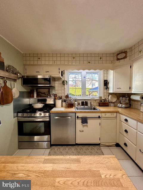 9203 Burbank Road Philadelphia, PA 19115 - Photo 31 of 62 a kitchen with stainless steel appliances granite countertop a stove and a sink