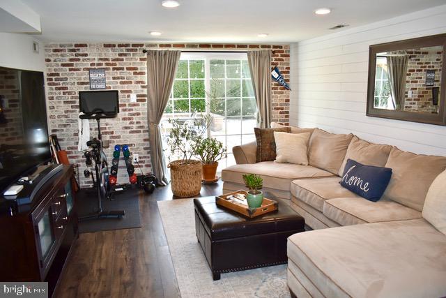 9203 Burbank Road Philadelphia, PA 19115 - Photo 9 of 62 a living room with furniture a flat screen tv and a fireplace