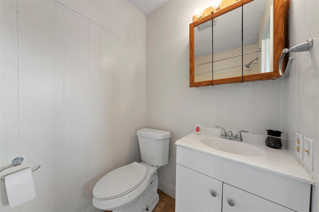 315 Winter Hawk McGregor, TX 76657 - Photo 7 of 15 a white toilet sitting next to a bathroom sink