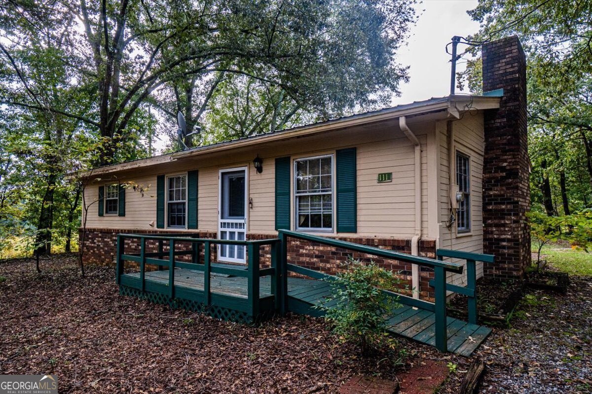 a backyard of a house with table and chairs