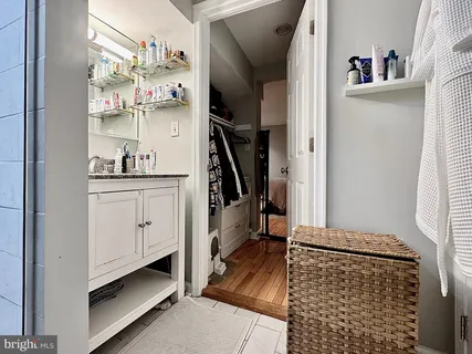 a kitchen with white cabinets and window