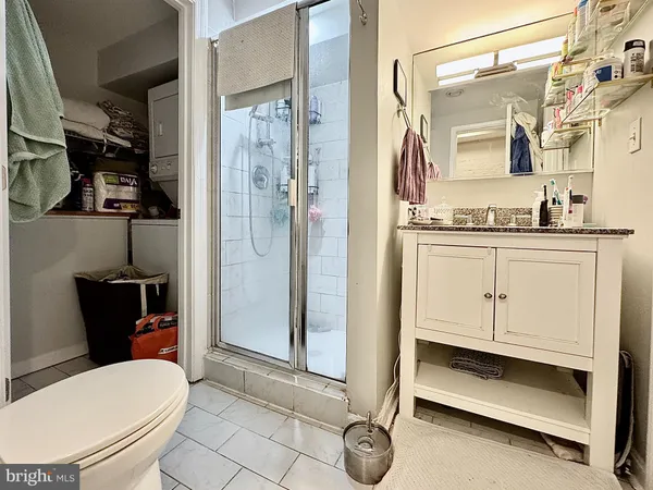 a bathroom with a toilet a sink and glass door