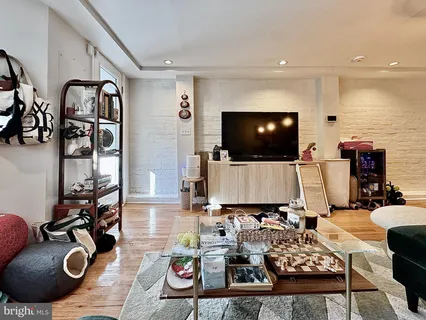 a living room with furniture and flat screen tv