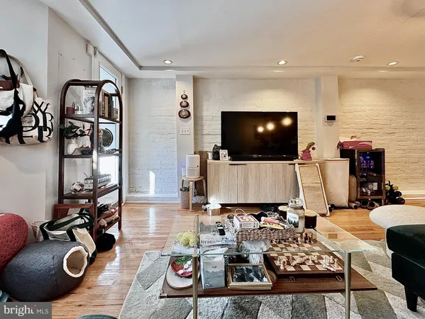 a living room with furniture and flat screen tv